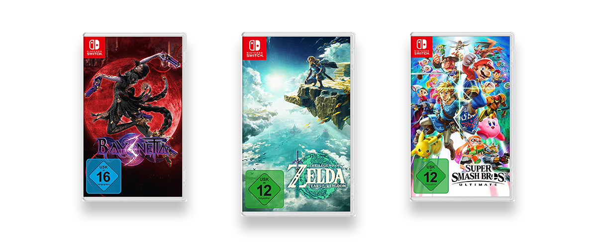 Drei Spiele-Packungen von Nintendo Switch Spielen vor weißem Hintergrund. Zu sehen sind Zelda, Bayonetta und Super Mario Smash Brothers.