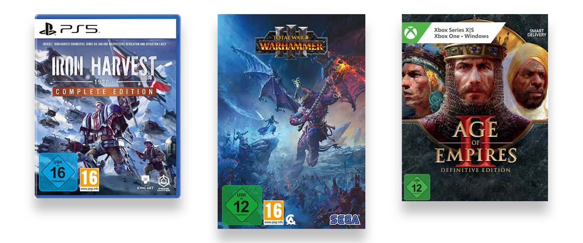 Die Packungen von drei verschiedenen Strategiespielen, nämlich Warhammer, Iron Harvest und Age of Empires.